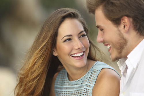 Invisalign® Couple smiling after receiving dental bonding